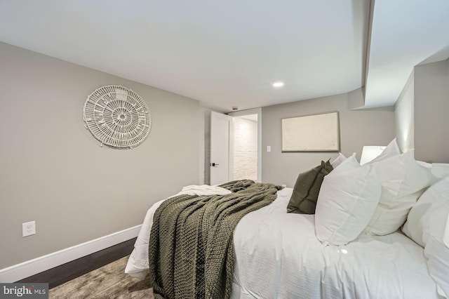 bedroom featuring baseboards and wood finished floors