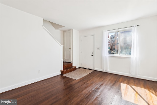 entryway with stairway, baseboards, and wood finished floors