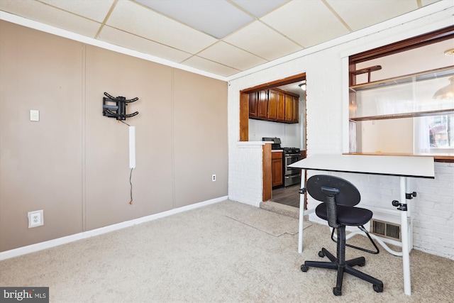 home office with a paneled ceiling, visible vents, and light carpet