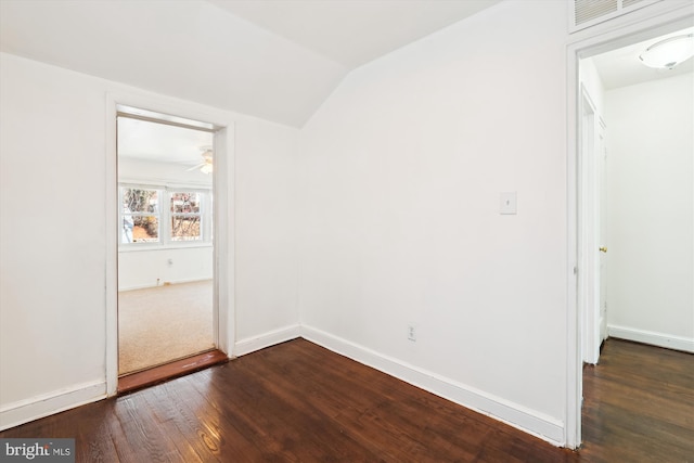 unfurnished bedroom featuring visible vents, baseboards, lofted ceiling, and dark wood-style flooring