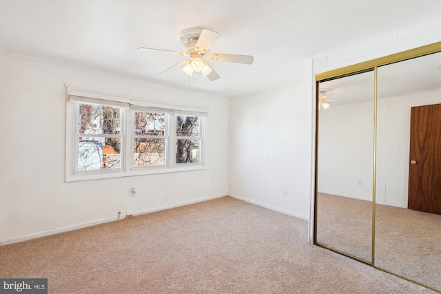 unfurnished bedroom with carpet, a closet, and ceiling fan