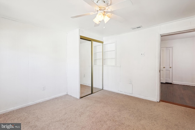 unfurnished bedroom with visible vents, carpet floors, a closet, and a ceiling fan