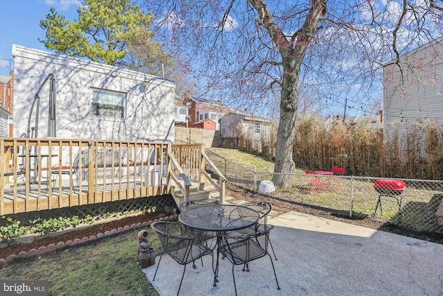 view of patio / terrace featuring a deck and fence