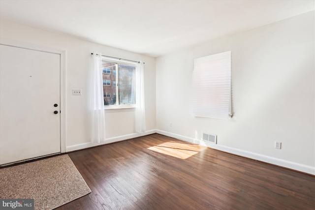 entryway featuring visible vents, baseboards, and wood finished floors