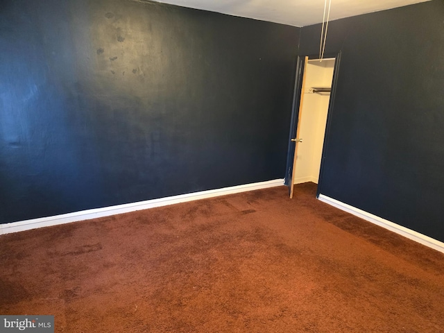 carpeted spare room with baseboards