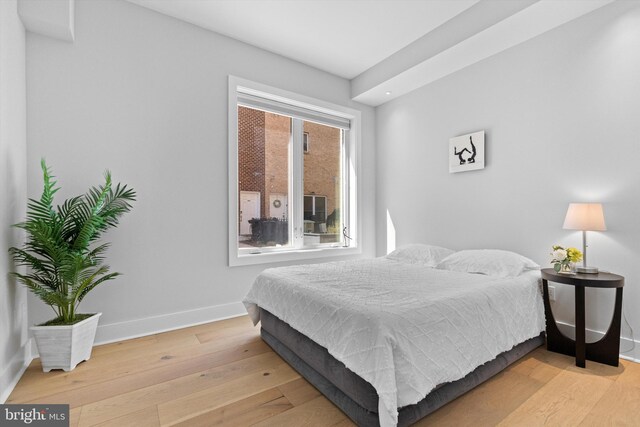 bedroom featuring baseboards and hardwood / wood-style floors