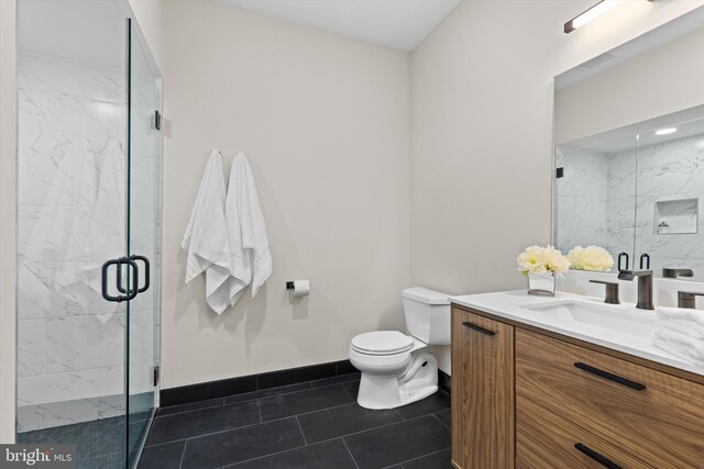 full bathroom with vanity, toilet, tile patterned flooring, and a marble finish shower