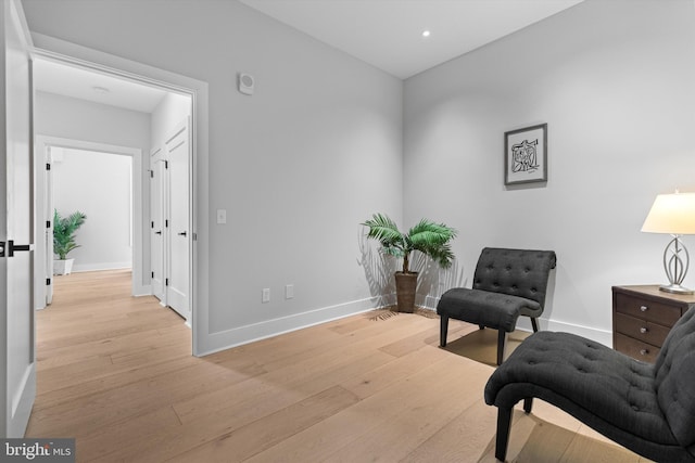 living area with recessed lighting, light wood-style flooring, and baseboards