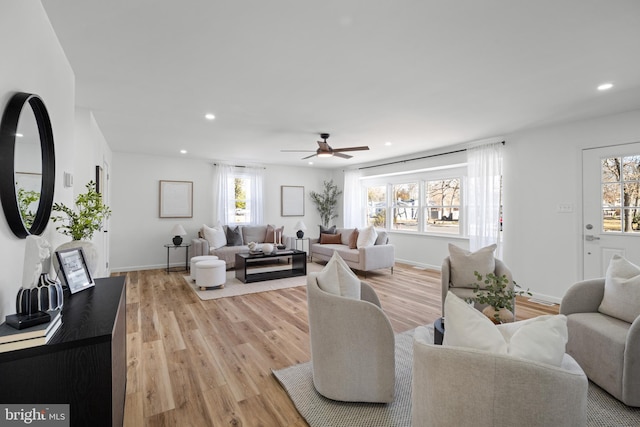 living area with recessed lighting, light wood-type flooring, baseboards, and ceiling fan