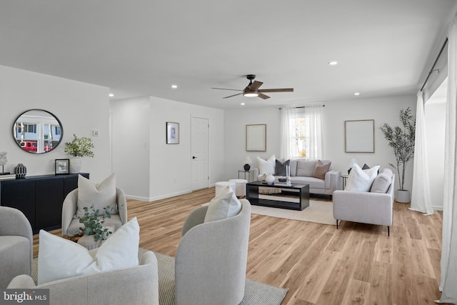 living area featuring recessed lighting, a ceiling fan, light wood-type flooring, and baseboards