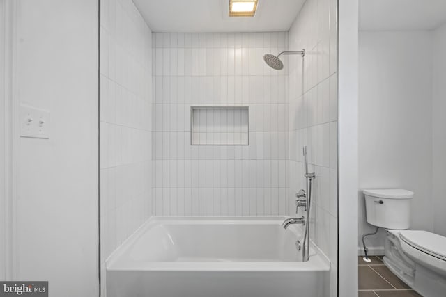 bathroom with toilet, shower / washtub combination, and tile patterned flooring