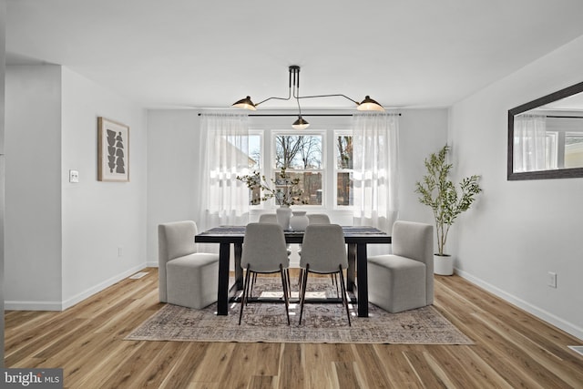 dining area featuring baseboards and wood finished floors