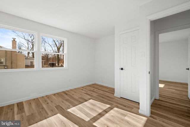 unfurnished bedroom featuring baseboards and wood finished floors