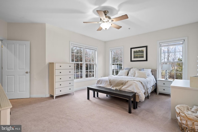 carpeted bedroom featuring ceiling fan and baseboards