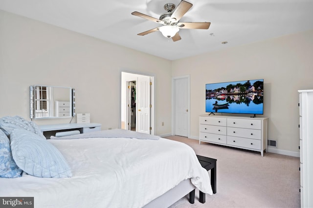 carpeted bedroom with ceiling fan and baseboards