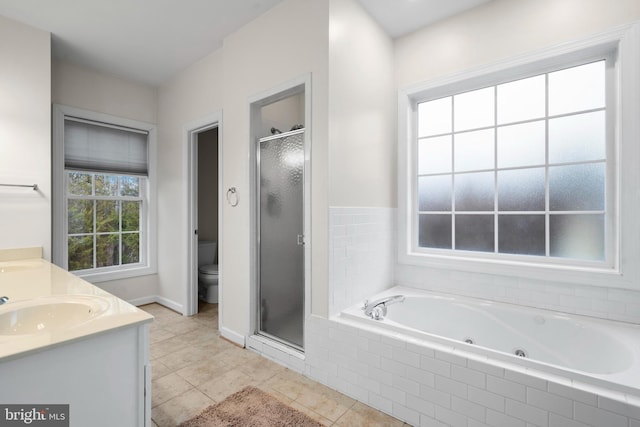 full bathroom with a sink, toilet, a tub with jets, and a shower stall