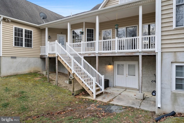 rear view of house with stairway and roof with shingles