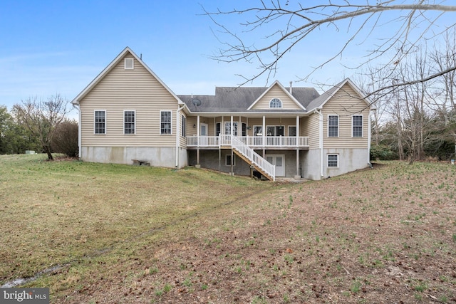 back of property with stairway and a yard