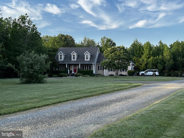 cape cod-style house featuring a front lawn