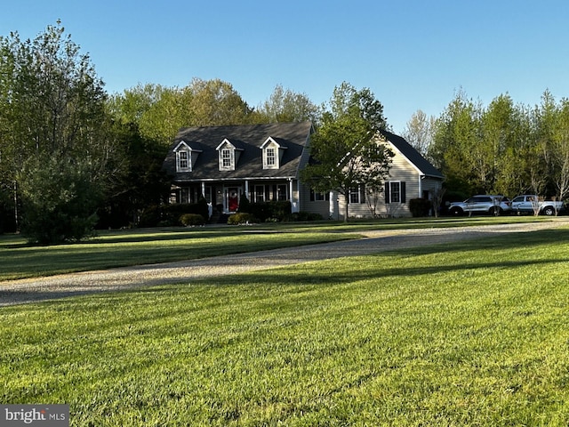 new england style home featuring a front lawn