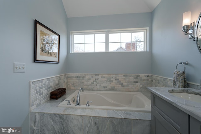 bathroom featuring vanity and a garden tub