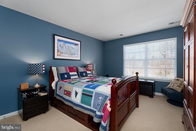 bedroom with visible vents, light carpet, and baseboards