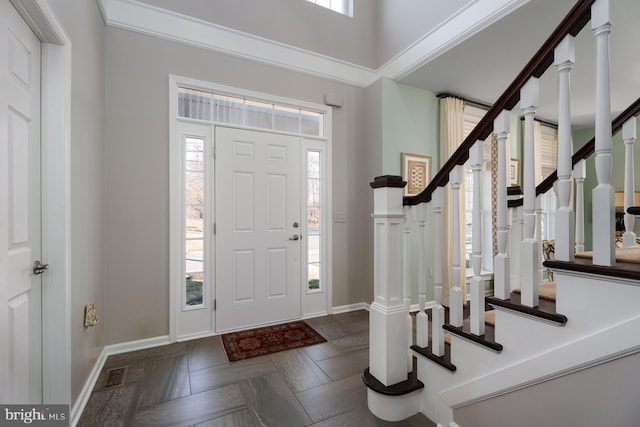 entryway featuring visible vents, stairs, and baseboards