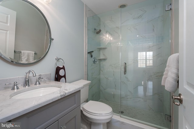 bathroom with vanity, toilet, marble finish floor, and a marble finish shower