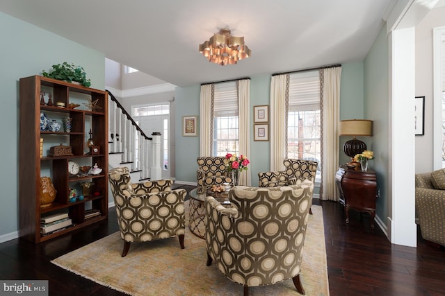 sitting room featuring dark wood-style floors, stairway, a chandelier, and baseboards