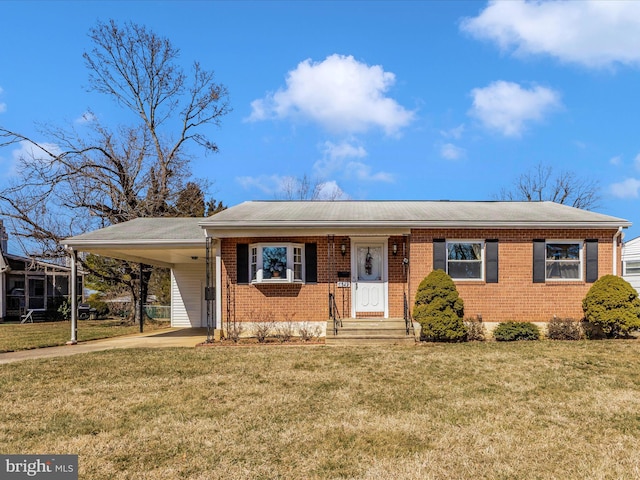 view of front of property with brick siding, a carport, concrete driveway, and a front lawn