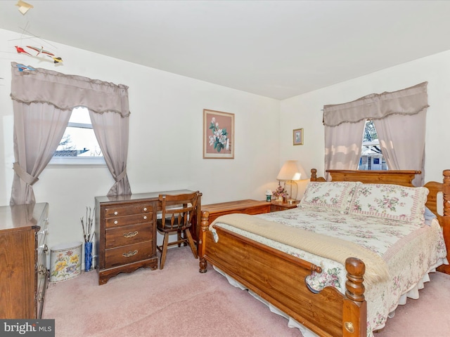 bedroom with multiple windows and carpet floors