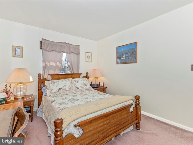 bedroom featuring baseboards and carpet