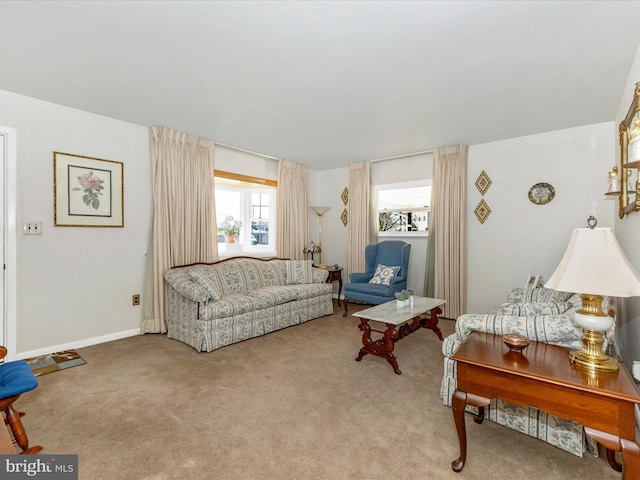 living room with baseboards and light colored carpet