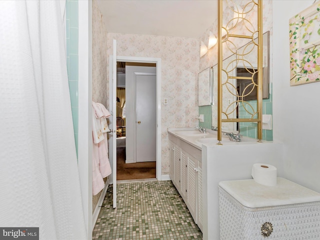 bathroom featuring wallpapered walls, a shower with shower curtain, and vanity