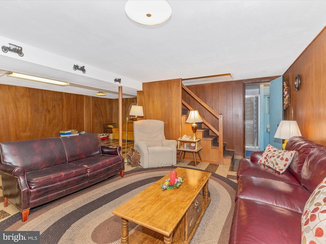 living area with stairway and wooden walls