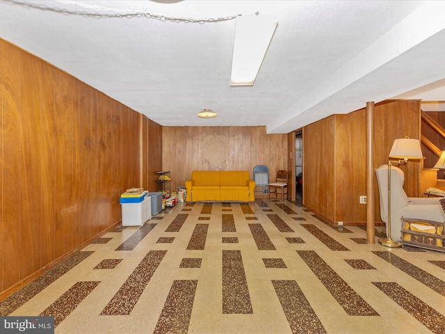 unfurnished room with wood walls and light floors