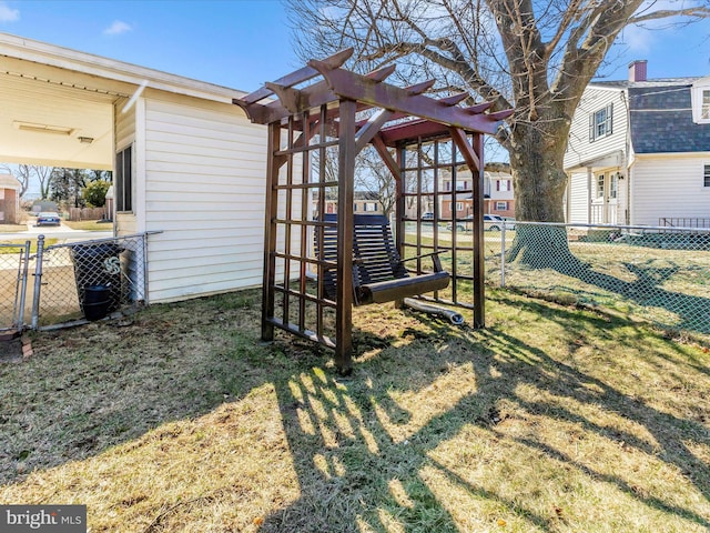 view of yard featuring a pergola and fence