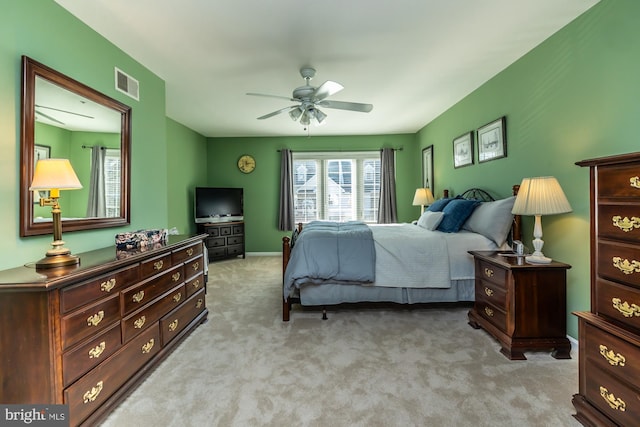 bedroom with visible vents, light carpet, and ceiling fan