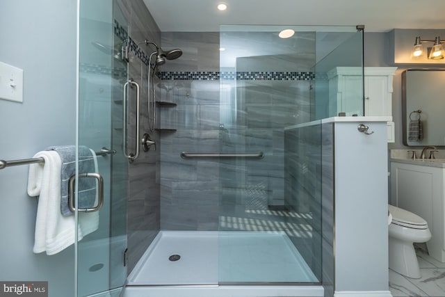 bathroom with vanity, a shower stall, toilet, and marble finish floor