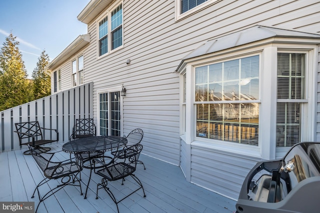 wooden terrace with outdoor dining area