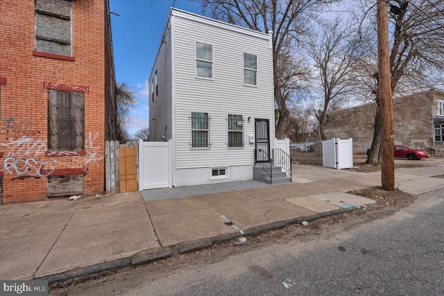 view of front of property with a gate and fence