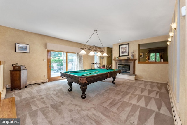 recreation room featuring a glass covered fireplace, carpet flooring, and a baseboard heating unit