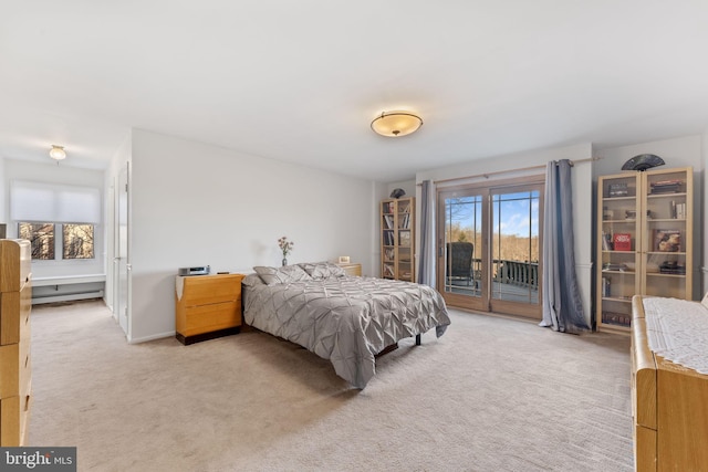 bedroom featuring access to exterior and light carpet