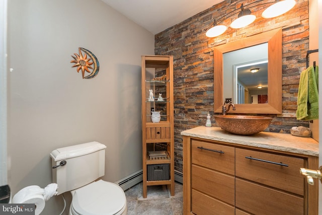 bathroom featuring baseboard heating, vanity, and toilet