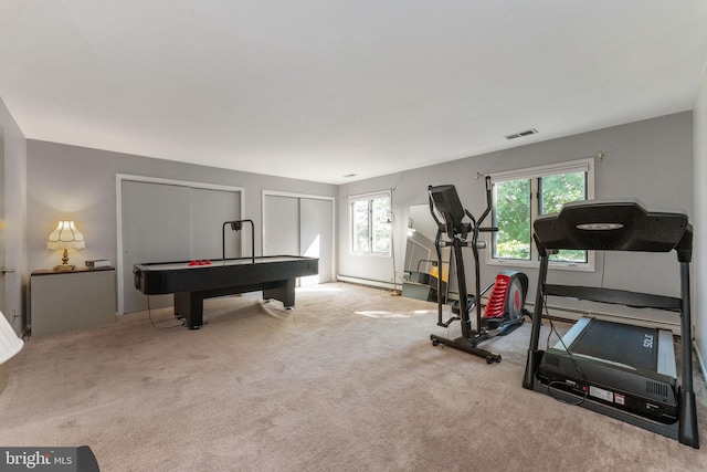 workout room with visible vents, baseboard heating, and carpet floors