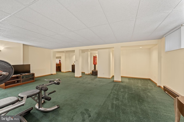 workout area featuring baseboard heating, baseboards, and carpet floors