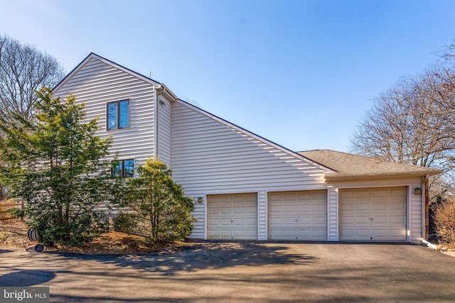 view of side of home with a garage