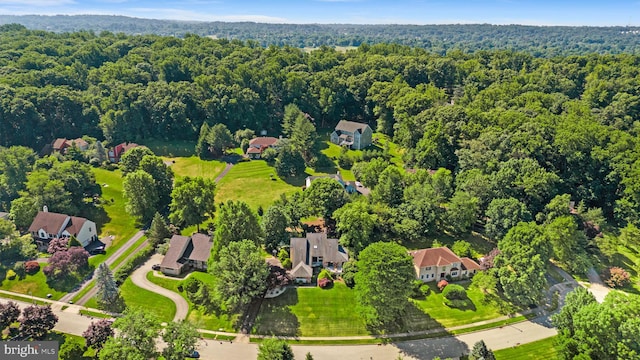 drone / aerial view with a residential view and a forest view