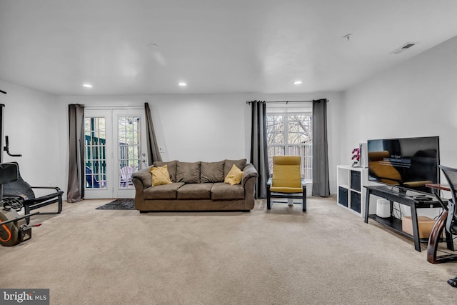 living room featuring carpet flooring, plenty of natural light, and recessed lighting