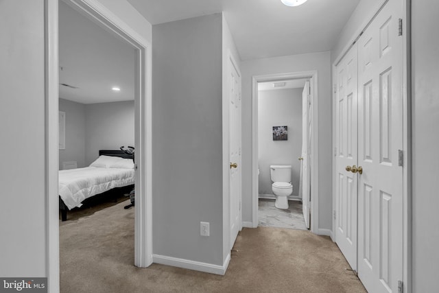 hallway with baseboards and carpet floors